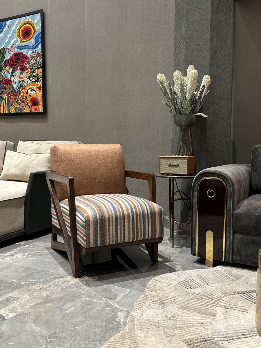 Statement armchair combining leather and striped upholstery
